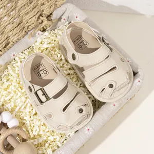 Closed-toe infant sandals in cream PU leather with soft soles and decorative buckles