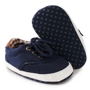 Detail of baby canvas walker shoe with non-slip soft sole and classic checkered lining