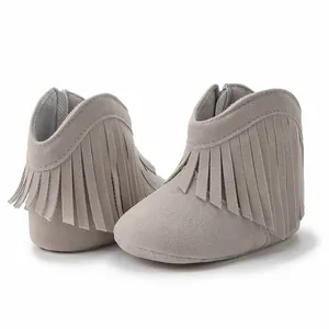 Detail of light gray baby fringe boots showing suede texture and rear zipper closure
