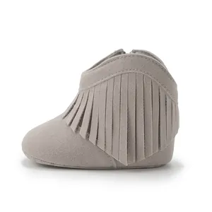 Detail view of baby fringe boots in light grey featuring a side zipper and soft sole