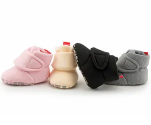 Detail of warm winter baby shoes with non-slip dots and fleece lining in four colors