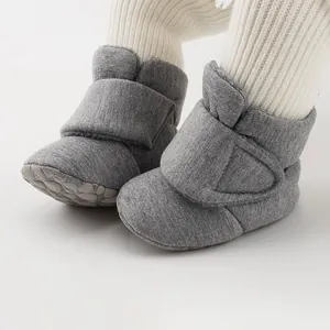 Detail of warm winter baby shoes in grey with soft non-slip soles and velcro straps