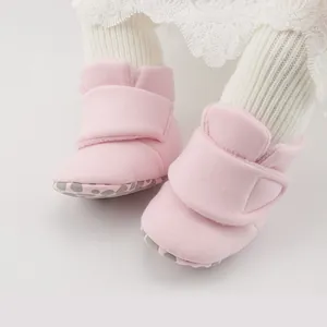 Detailed view of pink fleece baby shoes with anti-slip soles and adjustable velcro strap