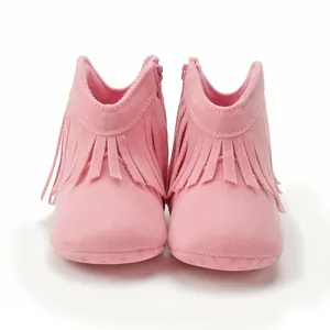 Detail of pink faux suede baby boots showing fringe trim and anti-slip rubber sole