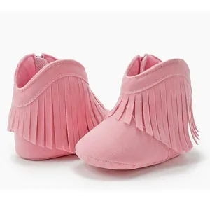 Detail of pink soft-soled baby fringe boots with suede texture and rear zipper closure