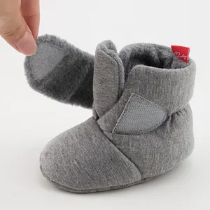 Detail of warm baby shoe showing soft grey fleece lining and velcro closure