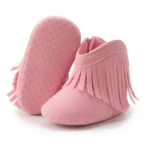 Detail of pink baby fringe boots showing anti-slip soft sole and suede texture