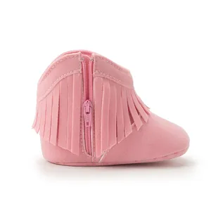 Detailed side view of pink suede baby boots with double tassel and side zipper