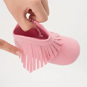 Detail of side zipper and soft inner lining on pink fringe suede baby boots
