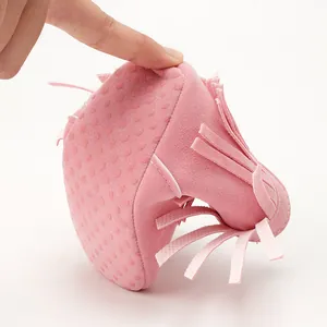 Close-up of pink soft-soled baby fringe boot showing extreme flexibility and non-slip dots