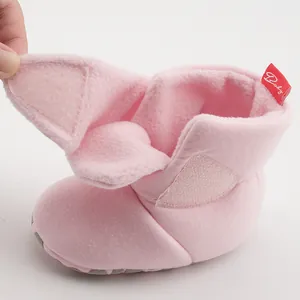 Detail of pink baby winter boots showing thick fleece lining and velcro closure