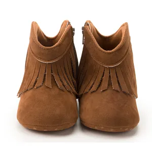 Detail view of brown fringe baby boots with soft sole and side zipper for infants
