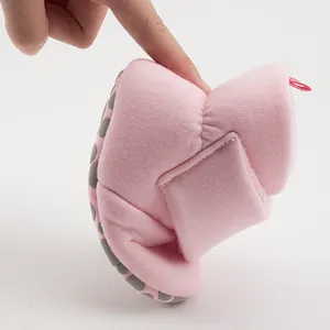 Close-up of pink baby shoes showing ultra-soft flexible sole and anti-slip silicone dots