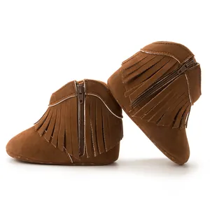 Detail shot of brown suede baby boots featuring stylish fringe and side zipper closure