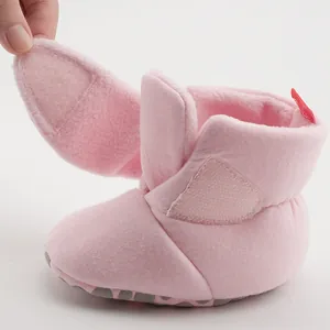 Detailed view of pink fleece baby boots with easy-to-use velcro closure and non-slip sole