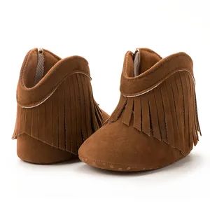 Detailed view of brown suede baby boots with fringe tassels and non-slip soles