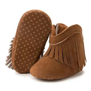 Close-up of brown fringe baby boots featuring anti-slip soft soles and suede texture