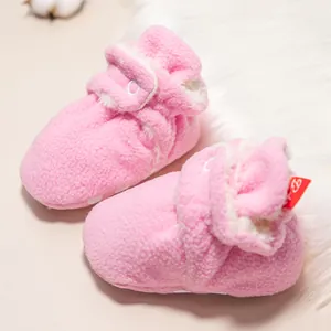 Nahaufnahme der rosa Fleece-Babyschuhe mit warmem Wollfutter und Klettverschluss-Detail