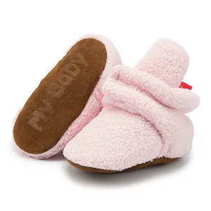 Detail of soft pink plush baby shoes with non-slip soles featuring my baby text