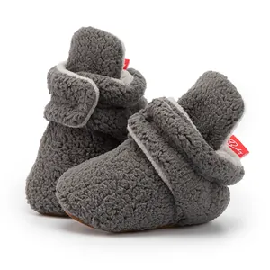 Close-up of warm grey fleece baby shoes with soft lining and adjustable velcro strap