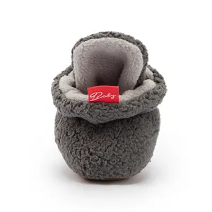 Detail view of gray baby winter boot with soft fleece lining and red Baby label