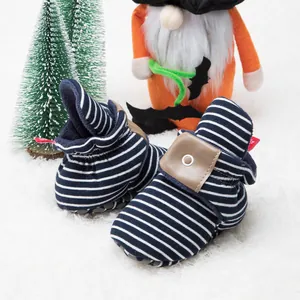 Detail of warm navy striped baby shoe with soft sole and leather velcro strap