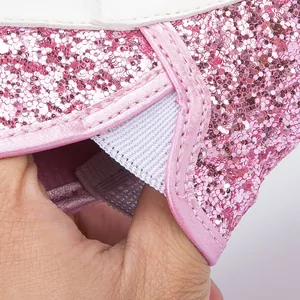 Close-up of flexible elastic opening and pink sequins on these baby walking shoes