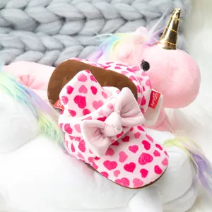 Pink heart-patterned baby walking shoes with bow detail and soft non-slip soles