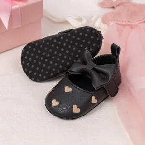 Infant girl princess shoes in black leather with gold hearts and large bow detail