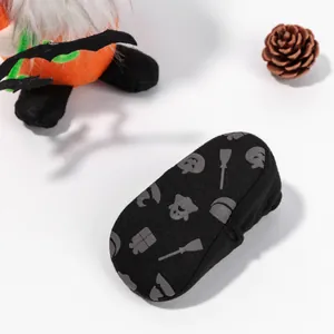 Detail of baby Halloween non-slip socks with glowing pumpkin and ghost grip patterns