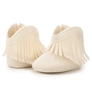 Detail of cream baby fringe boots featuring soft anti-slip soles and a back zipper closure