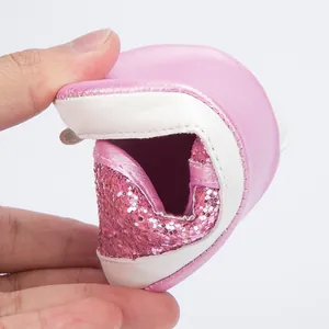 Detailed view of flexible non-slip soft sole on pink sequined toddler walking shoes