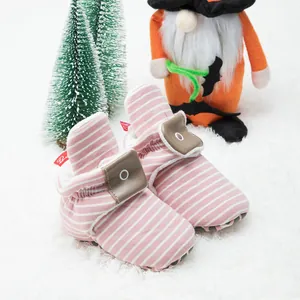 Detail of pink striped baby boots with warm fleece lining and non-slip soft soles