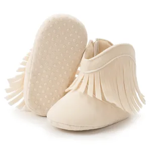 Detail of baby fringe boots showing non-slip sole and side zipper closure