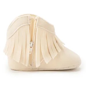 Detailed side view of beige suede baby fringe boots featuring a metallic side zipper