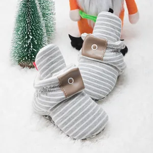 Detail of baby stripe sock shoes with non-slip soft soles and leather button buckle