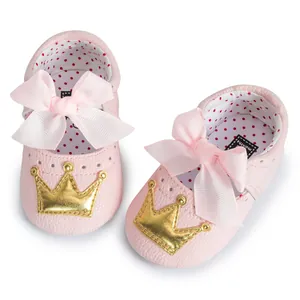 Pink soft sole baby walker shoes with gold crown appliqué and large ribbon bow detail