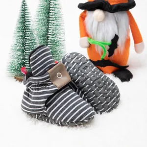 Detail of baby winter walking shoes with striped fabric and anti-slip rubber soles