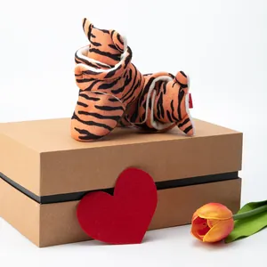 Detailed view of tiger print baby shoes with warm plush lining and a brown gift box