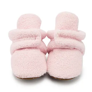 Pink fleece baby walking boots with soft non-slip soles and adjustable velcro straps