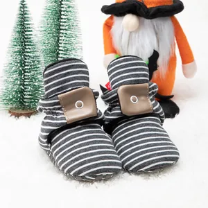 Detail view of winter baby socks shoes with grey stripes and non-slip soft soles