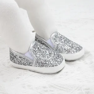 Close-up of baby girl silver sequin walking shoes with non-slip soft soles