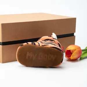 Detail of tiger print baby walker shoes with non-slip soles and soft velvet texture