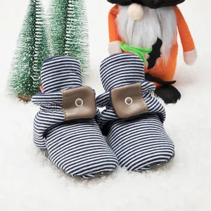 Detail view of baby winter walking shoes with blue stripes and non-slip soft soles