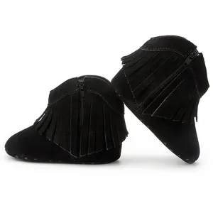 Detail view of black suede baby boots featuring multi-layer fringe and zipper closure