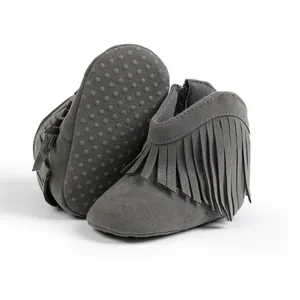 Detail shot of baby fringe boots with non-slip rubber dots on the soft soles