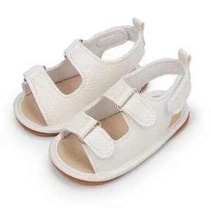 Close-up of cream PU leather baby sandals with textured finish and velcro straps