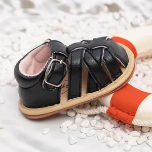 Detail of baby summer sandal featuring soft black leather straps and anti-slip sole