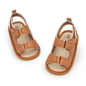 Close-up of brown PU leather baby sandals with hook-and-loop straps and soft soles