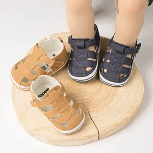 Détail de sandales bébé avec maille tissée respirante et sangles velcro sur socle en bois